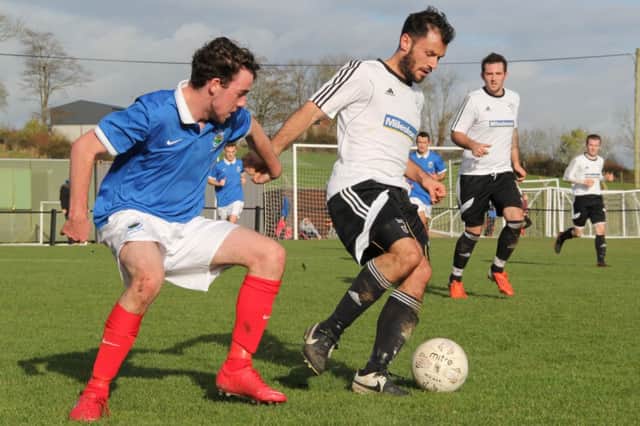 Rathfriland Rangers midfielder Stephen McArdle controls the ball as he comes under pressure from Chris Begley of Linfield Swifts. Photo: Iain McDowell / Rathfriland FC.