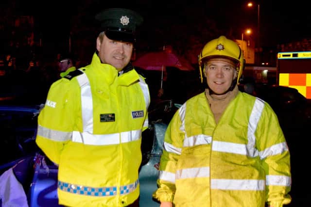 Constable Sid Henry from the Road Safety Unit and Crew Commander George Watson from Carrickfergus Fire Station during a road safety event held at the harbour car park. INCT 44-106-GR