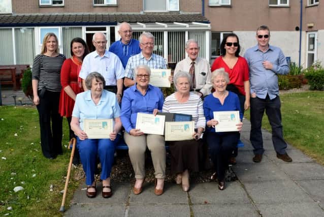 Fergus Fold residents receiving certificates for passing a course on the use of iPads run by Advice NI. INCT 41-166-GR