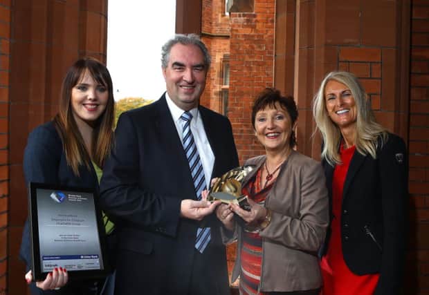 Colin Jess of Ulster Bank presents Clare Greenwood (left), Marie Marin and Zara Duffy from Employers For Childcare Charitable Group with an Ulster Bank Business Achiever Award for winning the Social Enterprise category at the Ulster final of the awards.