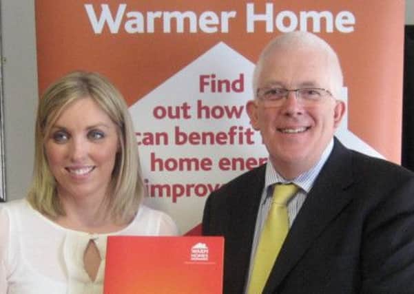 Stewart Dickson MLA and Sinead O'Boyle of Bryson Energy promote the benefits of a warmer home.  INCT 44-724-CON