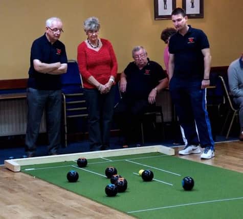 Competititors study the bowls during the recent match between British Legion and St Columba's US4214-407PM Pic by Paul Murphy