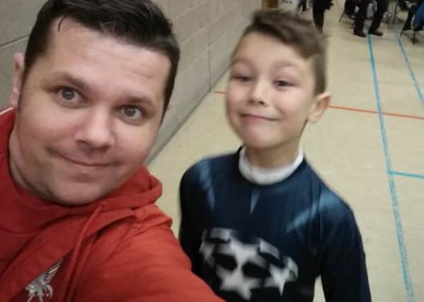 Dylan Armstrong and his dad Raymie pause for a selfie at the big game.