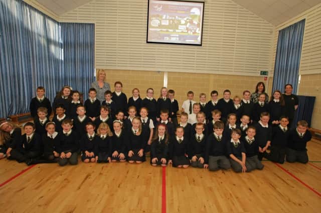 SING AT ASSEMBLY. Pictured along with staff are P5 pupils at St Patrick's & St Brigid's PS who sang at a special assembly on Friday attended by parents to launch the school's Website.INBM43-14 017SC.