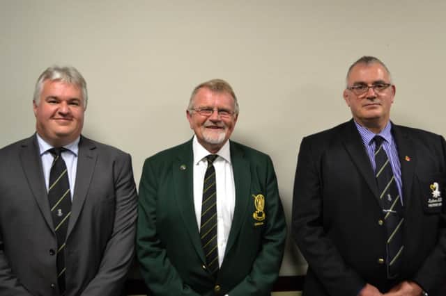 Lisburn Captain, Peter Cairns with Lisburn Rugby Club representatives William Gould and Dougie Durrant.