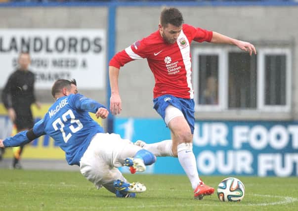 Glenavon'S Shane McCabe and Linfield's Stephen Lowry  in action.
