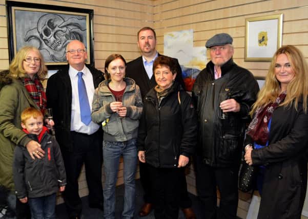 Councillor Billy Ashe with some of the artists whose work is on display in the pop up art gallery on North Street, Carrickfergus. INCT 45-149-GR