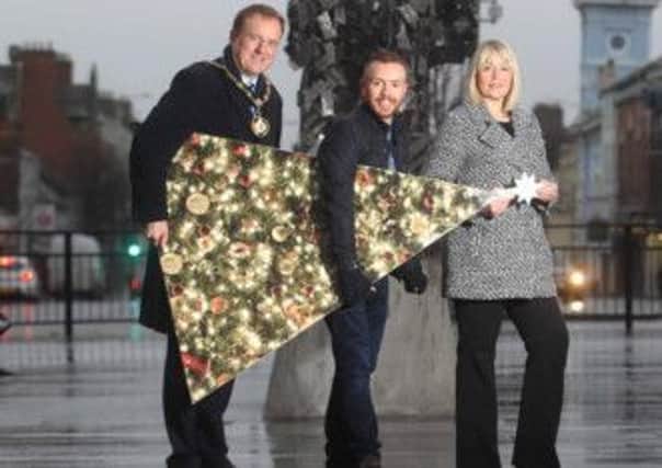 Getting ready for the annual switch on is Mayor of Craigavon Councillor Colin McCusker with local West End Star Conleth Kane and Town Centre Manager, Lyn McNeill.