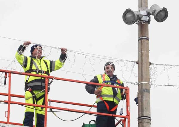 Coleraine Borough Council workers in Portstewart putting up the new Christmas lights. PICTURE MARK JAMIESON.