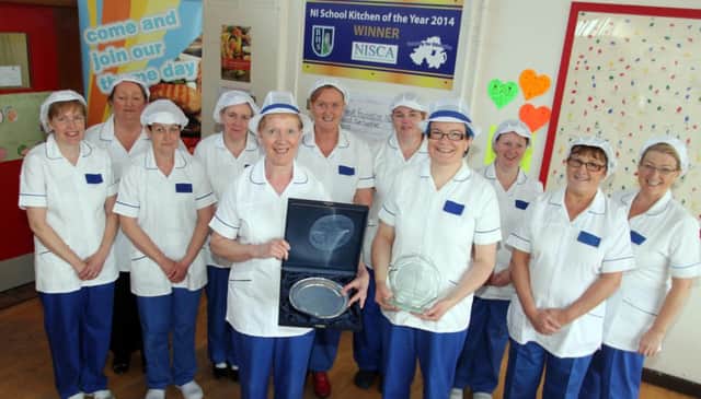 THE RIGHT INGREDIENTS. Kitchen Supervisor at Ballymoney High, Helen Paul, pictured with the NI School Kitchen of the Year award and her merry band of kitchen staff.INBM46-14 027SC.