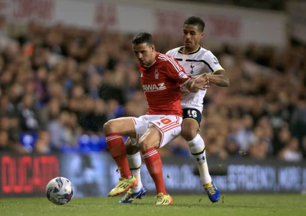 Nottingham Forest's Stephen McLaughlin and Tottenham Hotspur's Kyle Naughton battle for the ball during the Capital One Cup tie at White Hart Lane.