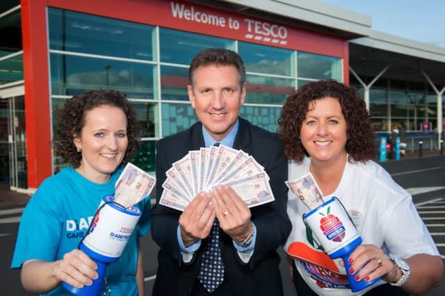 Celebrating reaching the landmark figure are Emma Corry from Diabetes UK (left) along with Tesco Ballymoney store manager Geoff Purcell and Jackie Brogan, the community champion in the Tesco Ballymoney store. INBM46-14S