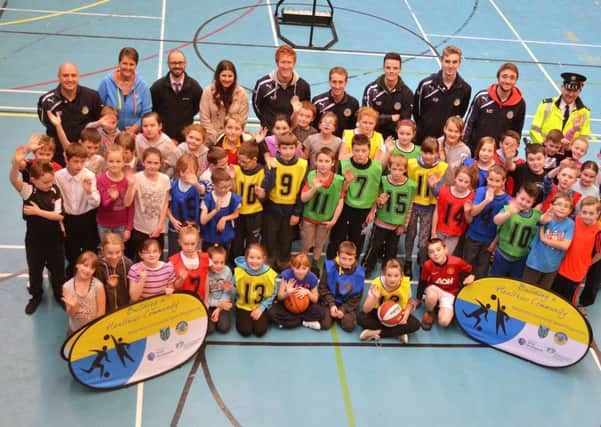 Constable McKee was photographed last week at the Seven Towers Leisure Centre with teachers, coaches and pupils of St Brigid's and Ballykeel PS who took part in the basketball twinning programme. INBT 46-801H