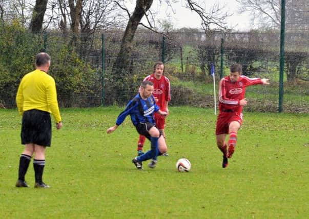 A Wakehurst Strollers player attempts to intercept a pass from a Clough Rangers Athletic player during Saturday's match. INBT 46-920H