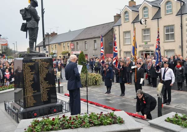 Councillor Beth Adger lays a poppy wreath as a mark of respect at Broughshane on Sunday. INBT 46-932H