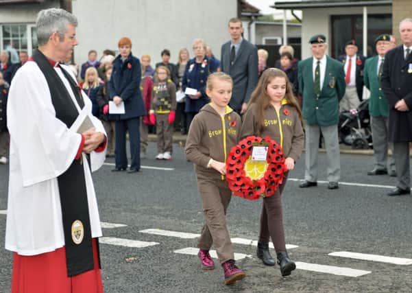 Members of 2nd Glynn Brownies and Rainbows lay a wreath at the Cenotaph in Glynn on Remembrance Sunday. INLT 46-023-PSB