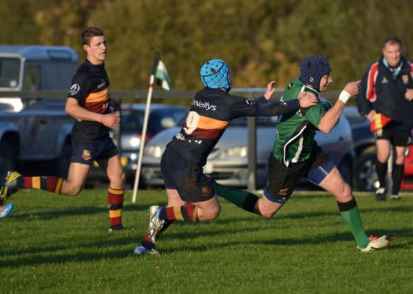 City of Derryâ¬"s Richard McCarter shrugs off this tackle from Banbridge player Aaron Kennedy on his way to scoring a try at Judges Road on Saturday. INLS4514-169KM