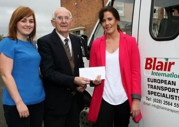 Rex Bonar, vice-president of Ballymena Road Club, receives a cheque Laura Blair and Fran Parrott of Blair International. INBT40-211AC