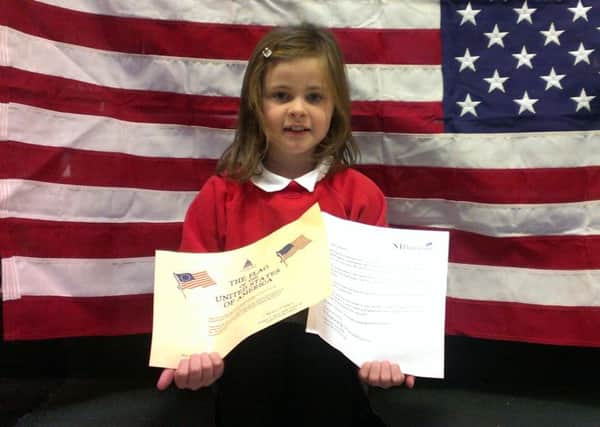 Katelyn Wark with her US flag, certificate and letter from the Director of the NI Bureau in Washington, Norman Houston.