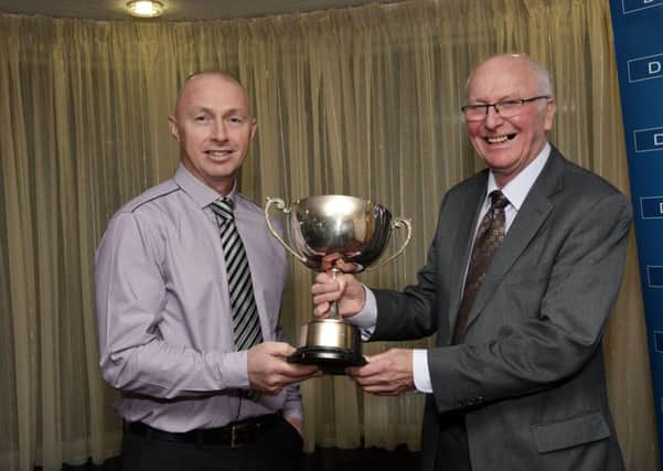 Ritchie Kelly, right, presenting the BBC Radio Foyle Player of the Year Cup to Decker Curry at the at the annual dinner held by the North West Cricket Union in the White Horse Hotel on Saturday night. INLS4514-161KM