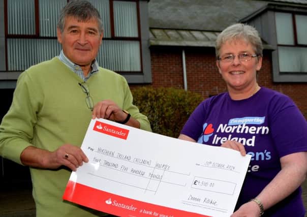 Jackie MacManus hands over a cheque for £4,500 to Catherine O'Hara, community appeals organiser, NI Children's Hospice. The 67-year-old Dunmurry man raised the money by completing the 500-mile Camino Way walk in Spain. INNT 45-104-GR