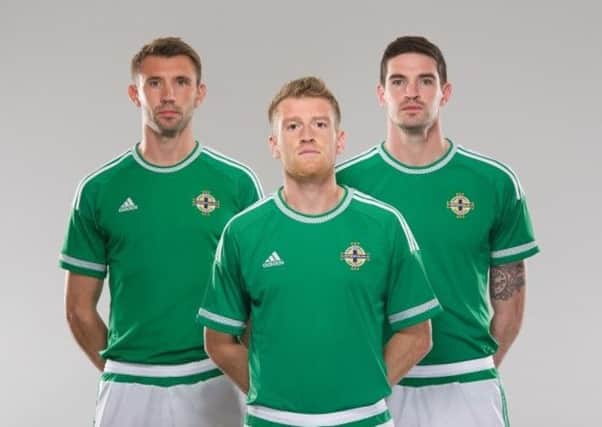 Larne man Gareth McAuley models the new-look Northern Ireland kit with fellow internationals Steven Davis and Kyle Lafferty. INLT 47-901-CON