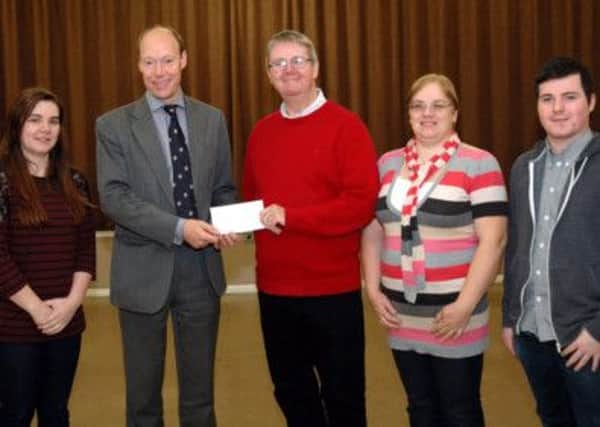 Pictured receiving the cheque  on behalf of the group is Mr Edmund Quigley. Also in the picture are Emma and Majella Quigley (Little Theatre Group) and Mr Daniel McMullan (St Josephs Parish Hall).