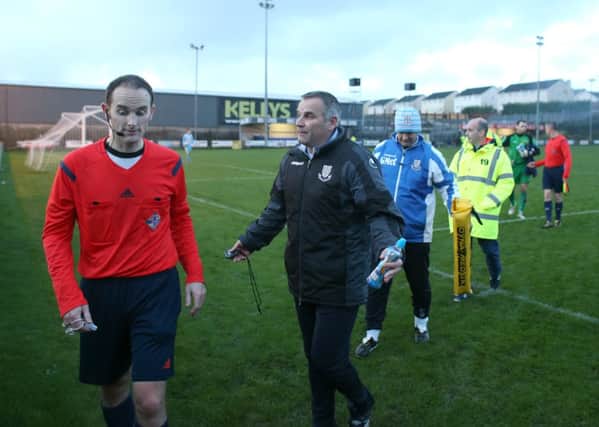 Ballymena United manager Glenn Ferguson has a discussion with referee Evan Boyce after play is suspended due to the floodlights not working in today's game at Warrenpoint Town. Picture: Press Eye.