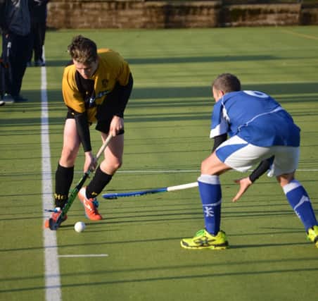 Portrush player Graeme Christie engaging with a Portadown opponent in last Saturday's league game played at Quay Road