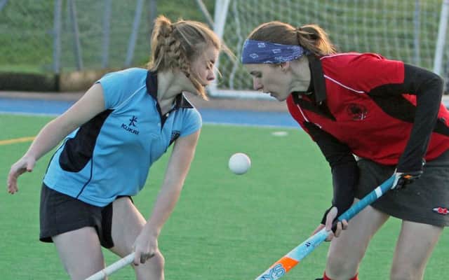 HEAD ON. Ballymoney 3rds player Lauren Henry (left) goes 'head to head' with her Annadale opponent on Saturday.INBM47-14 097SC.