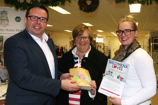 Gillian Reid, winner of the Ballymena Christmas Retail Experience, is pictured receiving almost £300 of gift vouchers for local shops from Rodney Kernohan of Ballymena Chamber of Commerce. Included is Grace Carmichael (Ballymena Town Centre Development). INBT47-223AC