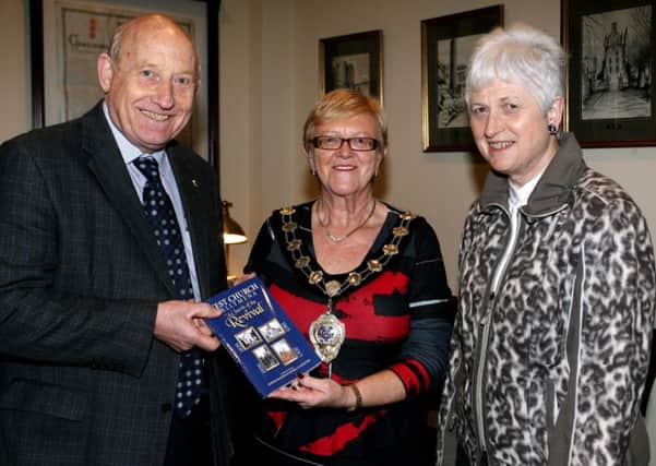 Maurice Livingstone and Jennifer McLernon are pictured presenting a copy of their new book "West Church Ballymena, A Church of the Revivial" to the Mayor of Ballymena, Cllr. Audrey Wales. INBT47-221AC