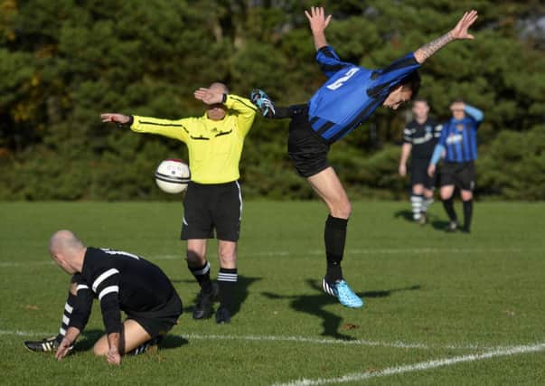BBOB's Jack Boyd flies through the air after this tackle from Ardmore midfielder Peter McLaughlin. INLS4614-102KM