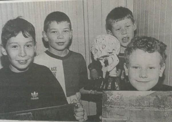 Picking up bargains at a sale in Whitehead Presbyterian Church hall in November 1997 and organised by its badminton club are Shea Kelly, Daniel Killen, David Boyd and David Logan. INCT 47-706-CON HIST