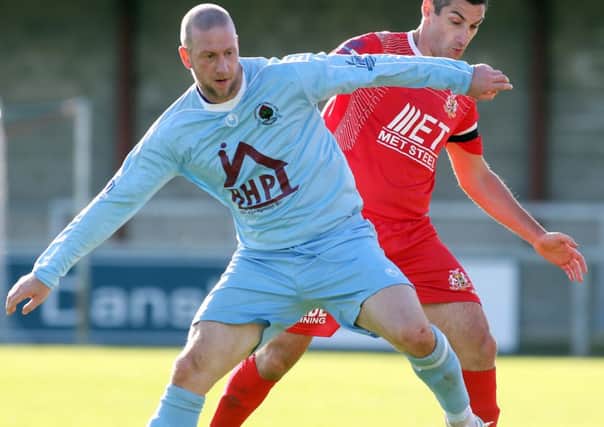 Institute's Stephen O'Flynn shields the ball from Portadown defender Keith O'Hara. Picture by Lorcan Doherty/Presseye.com
