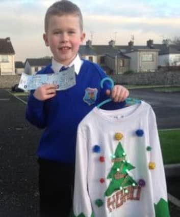 Nathan Cooke with his winning festive jumper and Cool FM jingle ball tickets.