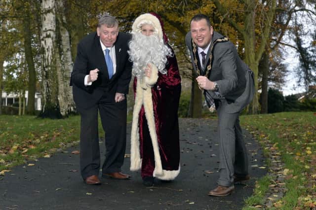 Alderman Paul Porter, Chairman of the Council's Leisure Services Committee is joined by Santa Claus and the Mayor of Lisburn, Councillor Andrew Ewing to launch the 2014 Santa Dash.