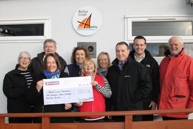 Donna Henderson, Department of Social Development Financial Management branch, presents  a £1300 cheque to  Anne Taylor, chairperson of Belfast Lough Sailabiliity, included (from left) are Christine Harper, Paul Bunting, Gillian McAdam (BLS); Kelly Caldwell, Davy Douglas, Padraig ONeill (DSD) and Bob Harper (BLS) (photo by Jim Hetherington). INCT 47-793-CON