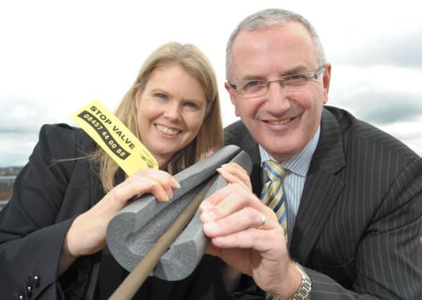 Regional Development Minister, Danny Kennedy, and NI Waters CEO, Sara Venning, encourage the public to lag their pipes and use the stop valve tag to locate their stop tap.