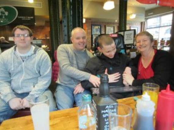 Christopher with mum Bernie, dad Sean and brother Adam