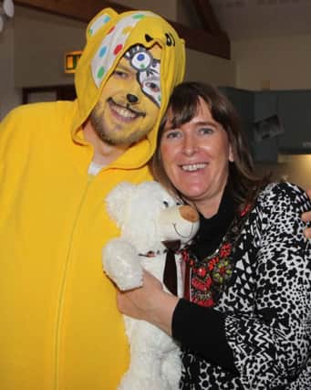 BEAR HUG. Marie-Louise McClarey from Corrymeela, pictured with Pudsey during a Children in Need fundrasing event on Friday.INBM48-14 012SC.