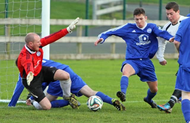 NO MOORE. Ballymoney Utd keeper, Brian Moore stops this shot from entering the net during his side's 2-1 home defeat to Portstewart on Saturday.INBM48-14 042SC.