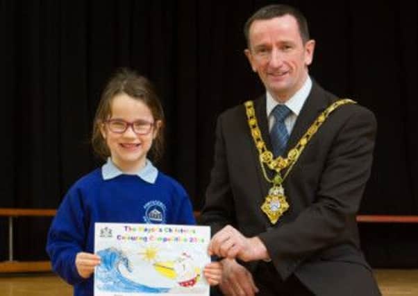 Pictured with Mayor Duddy is Jenna Hunt, Portstewart Primary School, who is one of the seven lucky children selected to help the Mayor of Coleraine, Councillor George Duddy and Santa Claus switch on the Christmas lights in their towns this Christmas! INCR48-115(S)