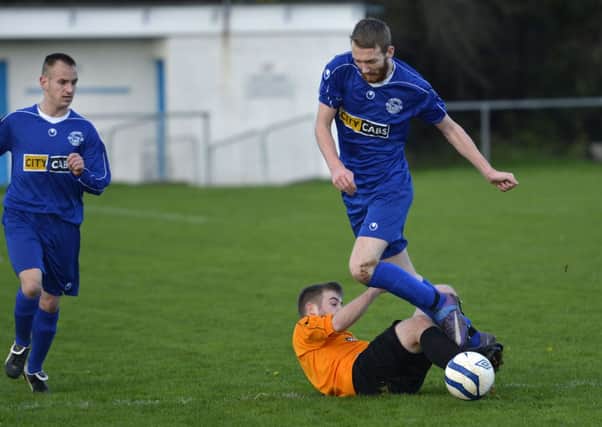 Lisahally's Mark Duffy slides in to tackle Churchill United player Danny Allen. INLS4714-156KM