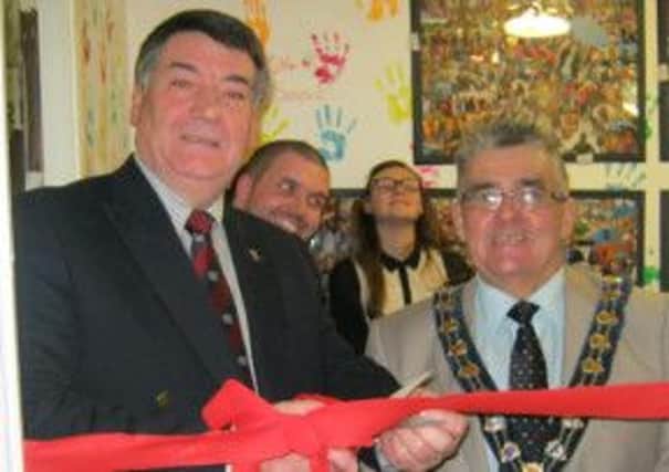 PCSP chairman, Councillor Noel Williams cuts the ribbon of the new teens' room at the Glenfield PAKT house.  Also pictured is Mayor, Alderman Charlie Johnston.  INCT 48-726-CON