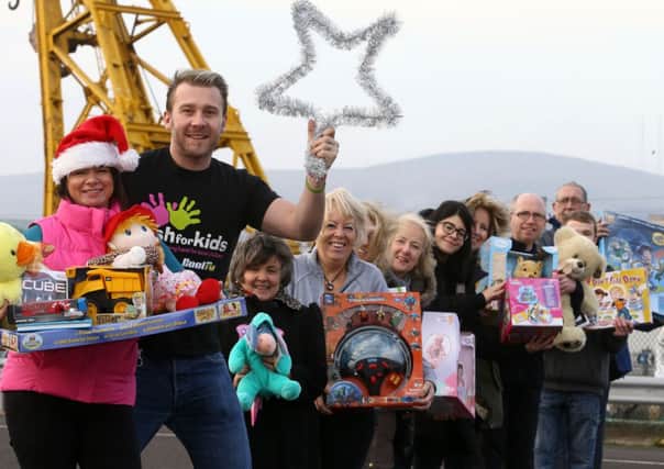 Lindsay Armstrong, Volunteer Now, joins Darren Fowler and a team of volunteers who are giving up some time to help with the 'Cash for Kids' Mission Christmas Toy Appeal. Pic by William Cherry. INLT 48-655-CON