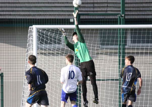 Cookstown Youth Under 18s keeper Chris Reynolds pulls off an acrobatic save against Hillhead