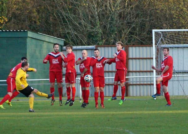 Ballyclare Comrades defend this free-kick in Saturday's defeat to HW Welders at Tillysburn Park.