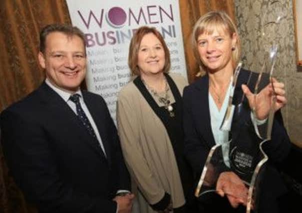 Janet McCollum of Moy Park receives the Women in Business NI Outstanding Business Woman of the Year Award for 2014 from Jeremy Fitch of Invest Northern Ireland and Roseann Kelly of Women in Business NI.