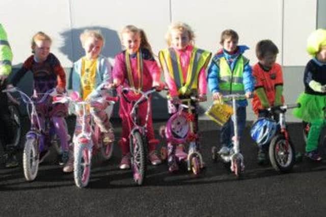 Some children from Gaelscoil an Chaistil who decorated their bikes and scooters in bright colours for Ditch The Dark day. INBM49-14S